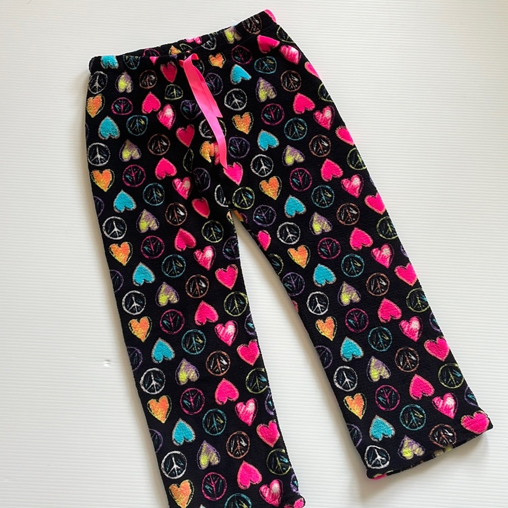 Just Dream it black pajama pants with hearts, & peace signs. Girls size large